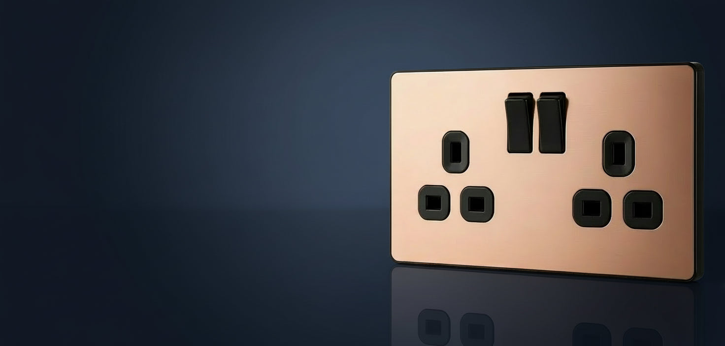 Copper-colored electrical switch with black rocker switches on a white background